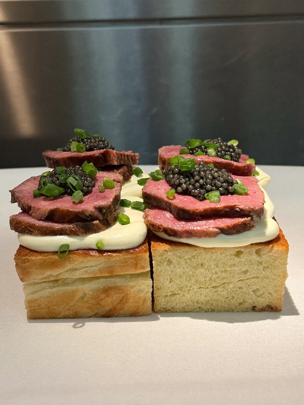 Seared beef with caviar on toasted bread.