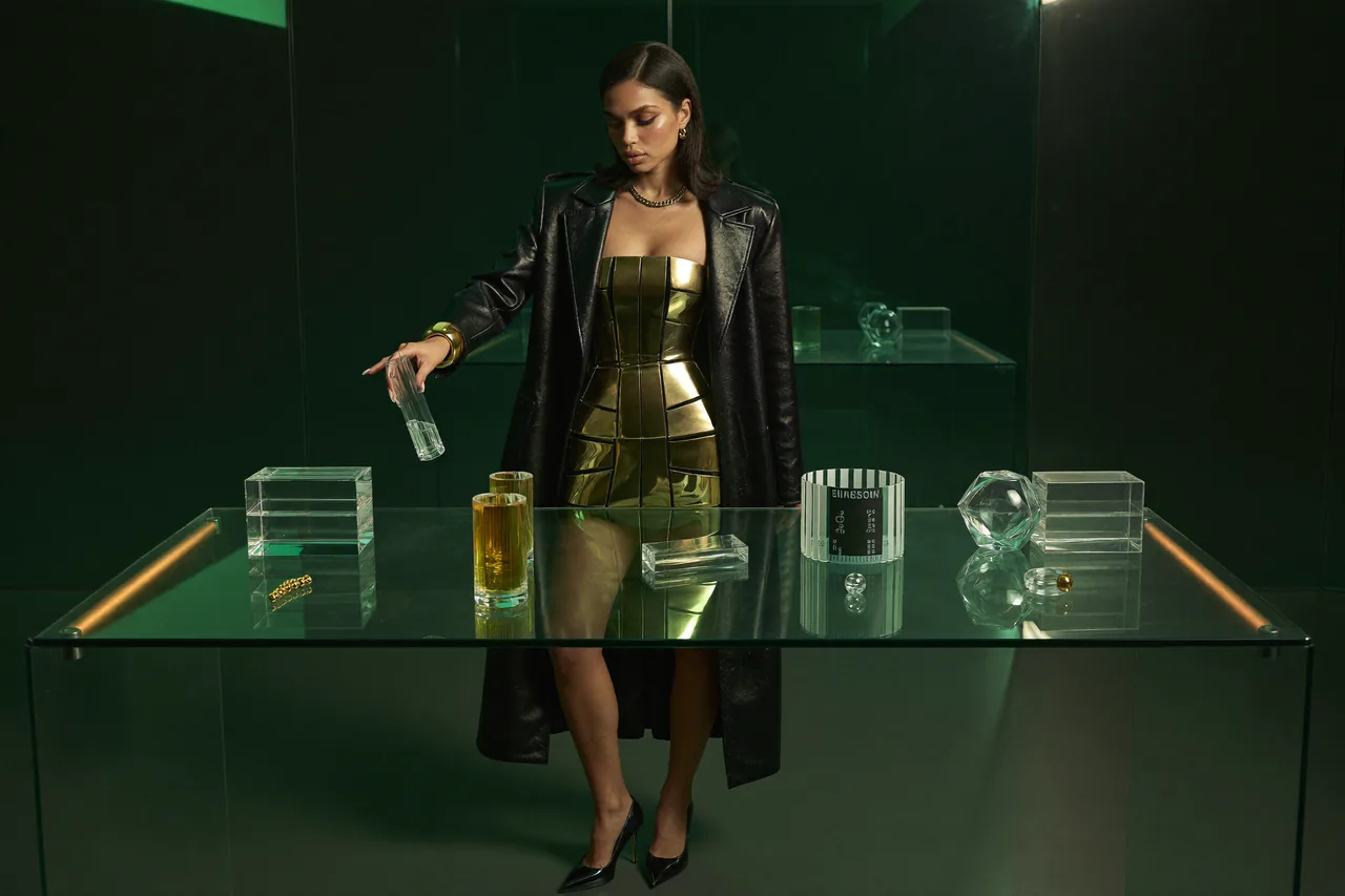 Seven Yuno arranges glass prototypes on a glass table.